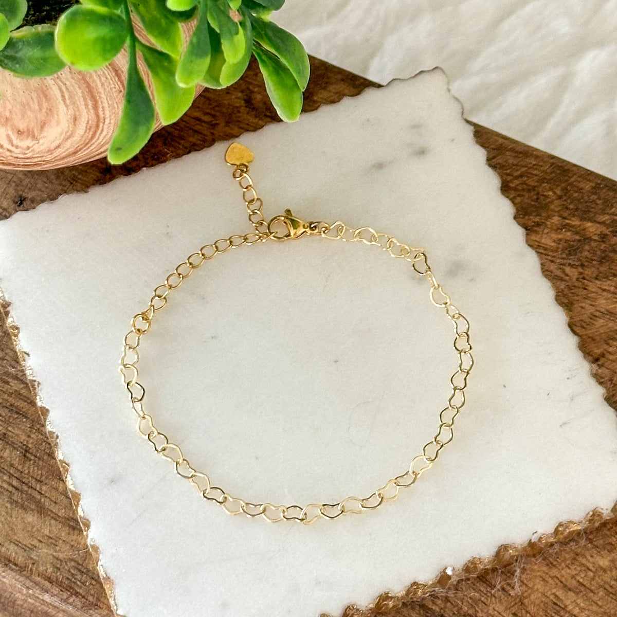 Filigree heart-link bracelet with a delicate key pendant