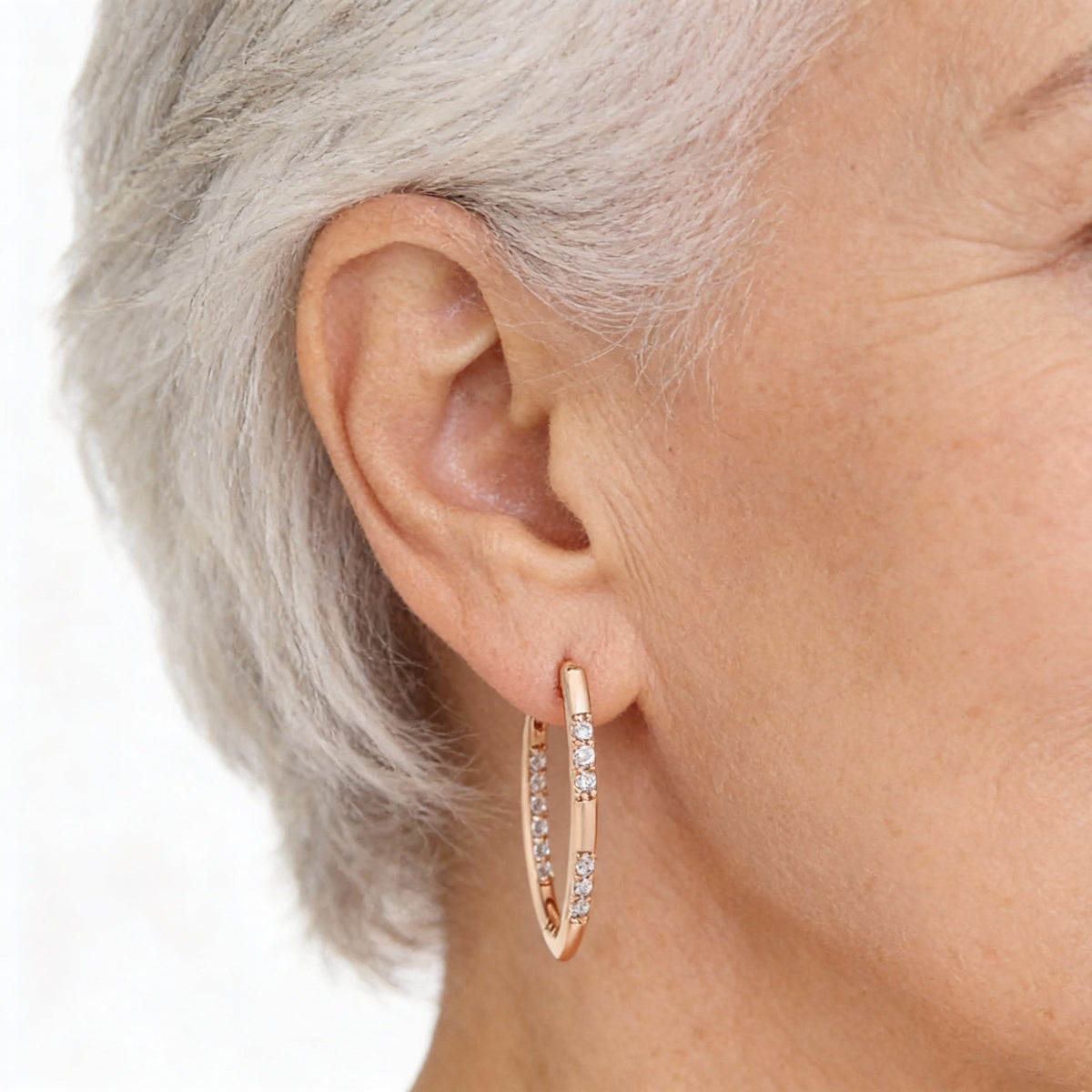 Shiny oval hoop earrings with cubic zirconia and an elegant design