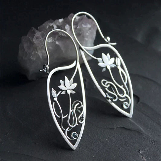 Lotus flower earrings crafted from oxidised silver-colored metal with delicate details