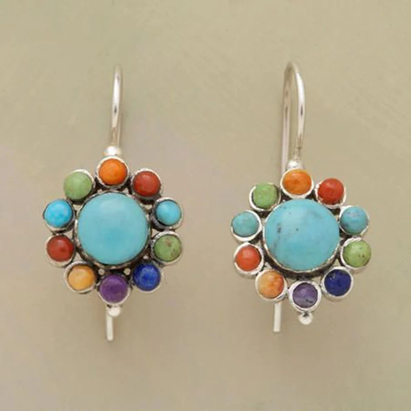 Round turquoise earrings with coloured stones and a floral design
