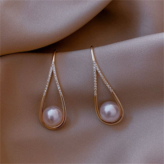 Elegant teardrop-shaped earrings with pearls and sparkling gemstones