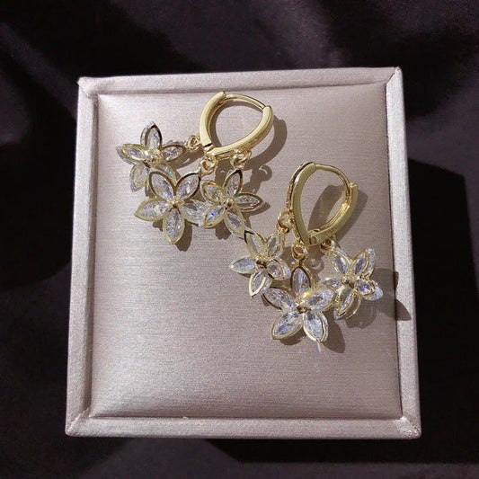 Flower-shaped earrings with sparkling cubic zirconia stones for elegant, stylish women