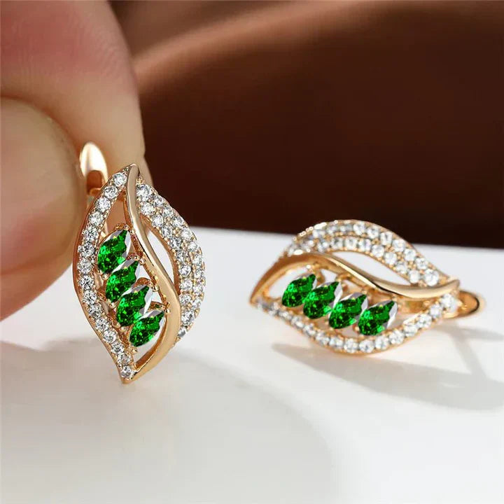 Earrings featuring leaf-shaped, sparkling green cubic zirconia stones, embellished with sparkling stones
