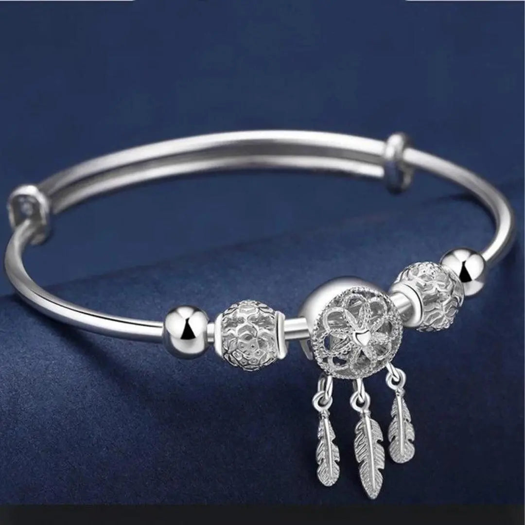 Filigree dreamcatcher bracelet with feather pendants and decorative beads