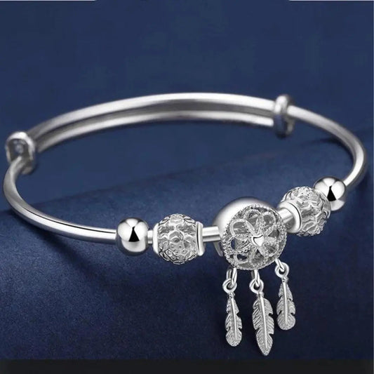 Filigree dreamcatcher bracelet with feather pendants and decorative beads