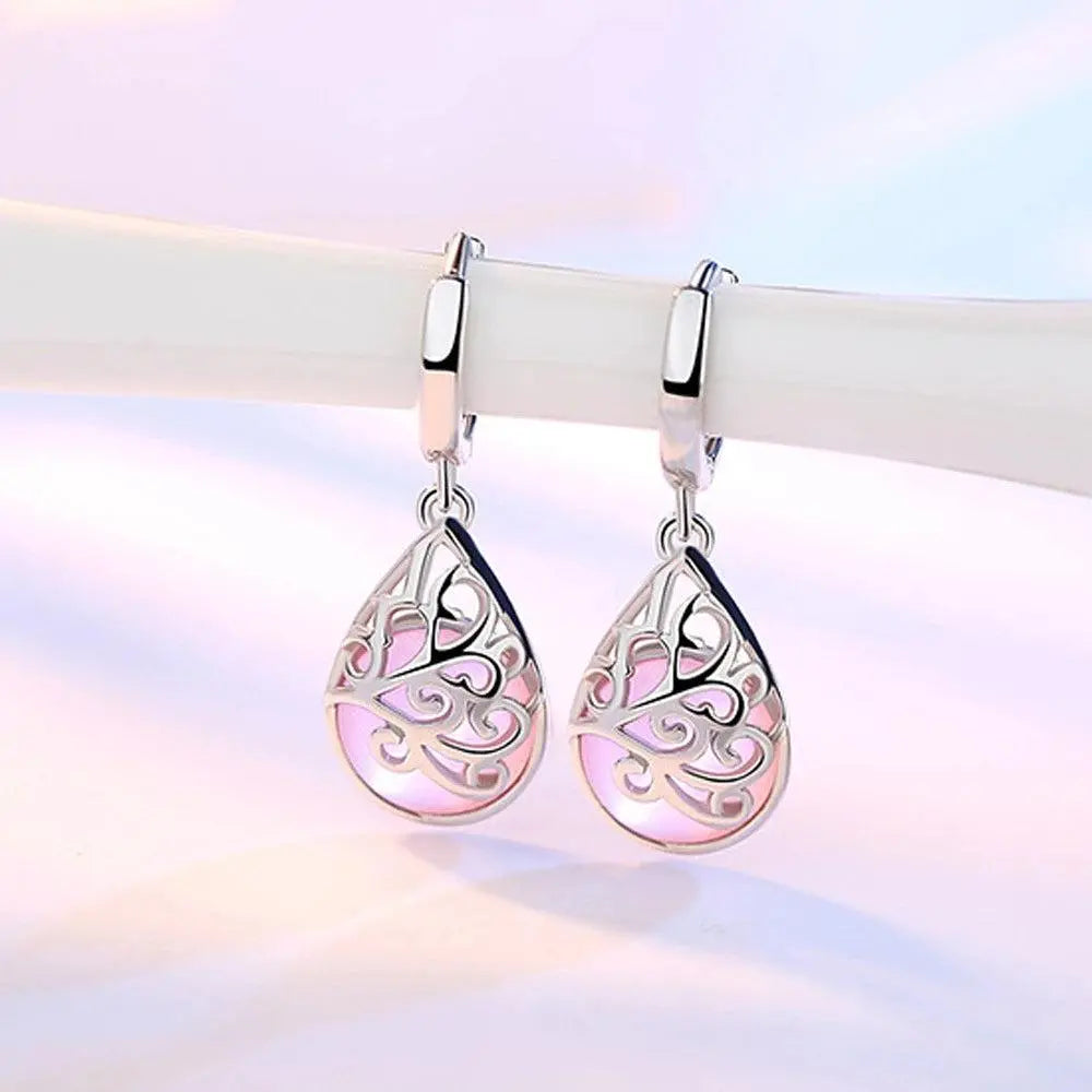 Elegant teardrop-shaped earrings with a pink stone and filigree design