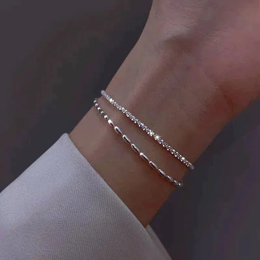 A glamorous cubic zirconia bracelet with an elegant pearl necklace