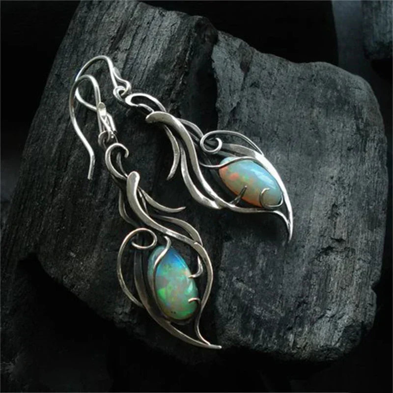 Vintage iridescent opal earrings featuring an artistic leaf design