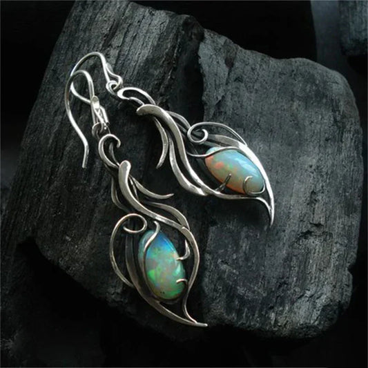 Vintage iridescent opal earrings featuring an artistic leaf design