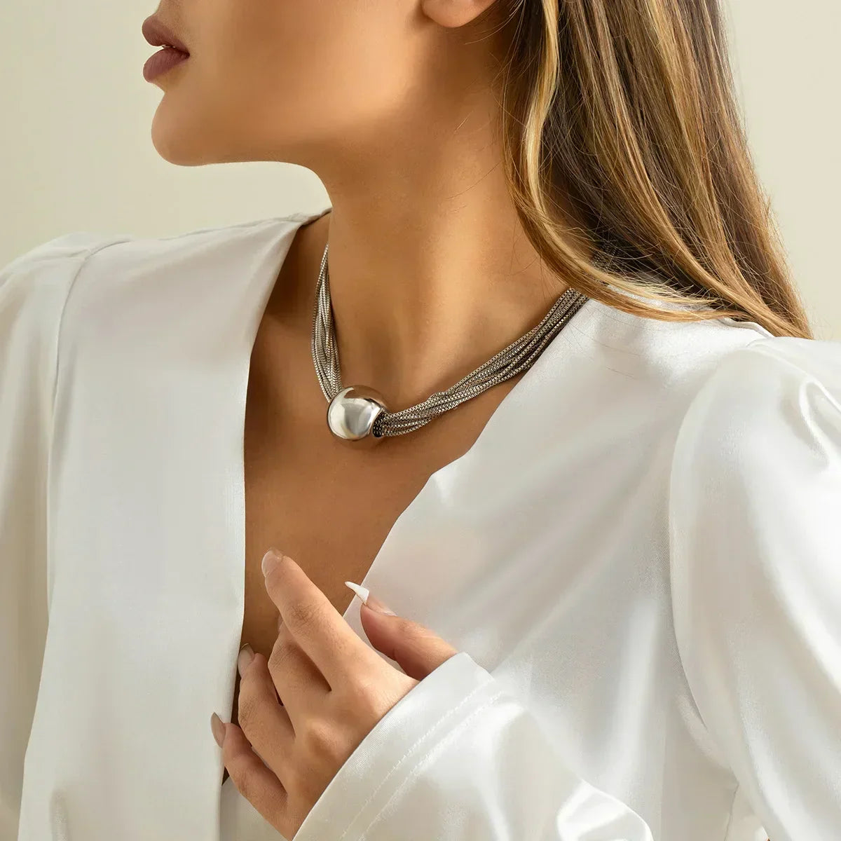 Elegant Multi-Row Necklace with Shimmering Metal Ball Pendant