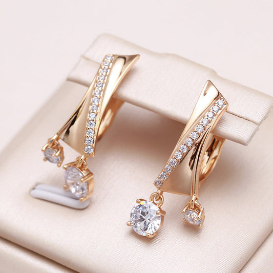 Sparkling cubic zirconia earrings with an elegant gold finish and a clasp