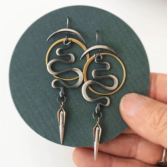 Mystical spiral snake earrings with a crescent moon and dagger details