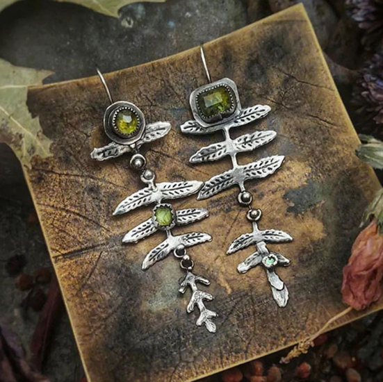 Earrings featuring natural leaves set with bright green peridot stones
