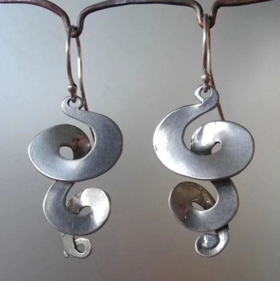 Antique ethnic spiral earrings with ornate Celtic motifs