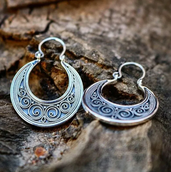 Antique ethnic spiral earrings with ornate Celtic motifs