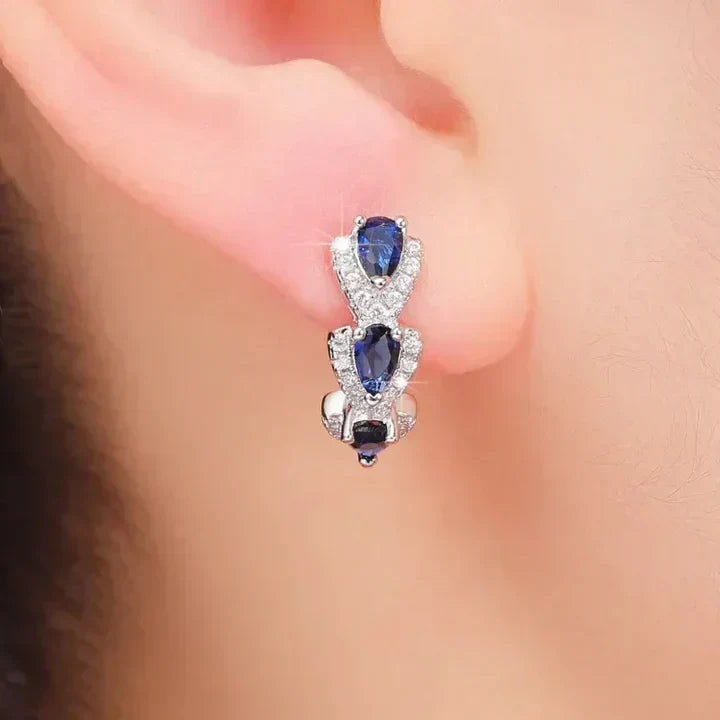 Elegant earrings featuring blue sapphire teardrops and sparkling cubic zirconia stones