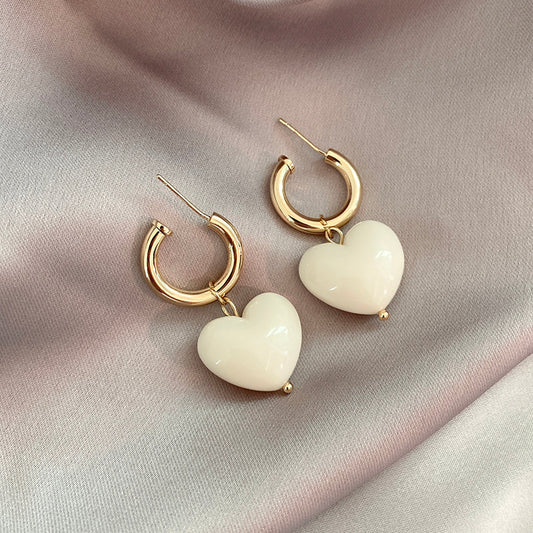 Elegant hoop earrings with sparkling white heart pendants