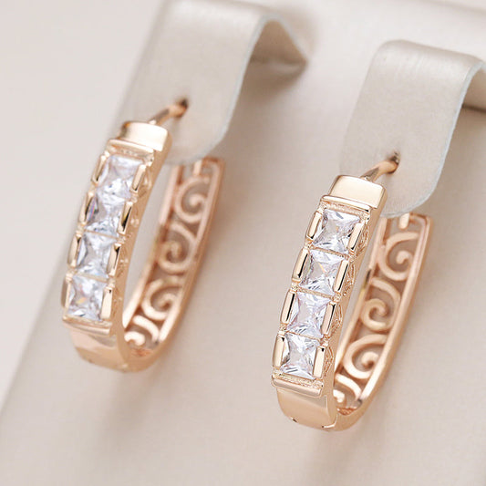 Elegant rose gold hoop earrings with sparkling cubic zirconia and an artistic design