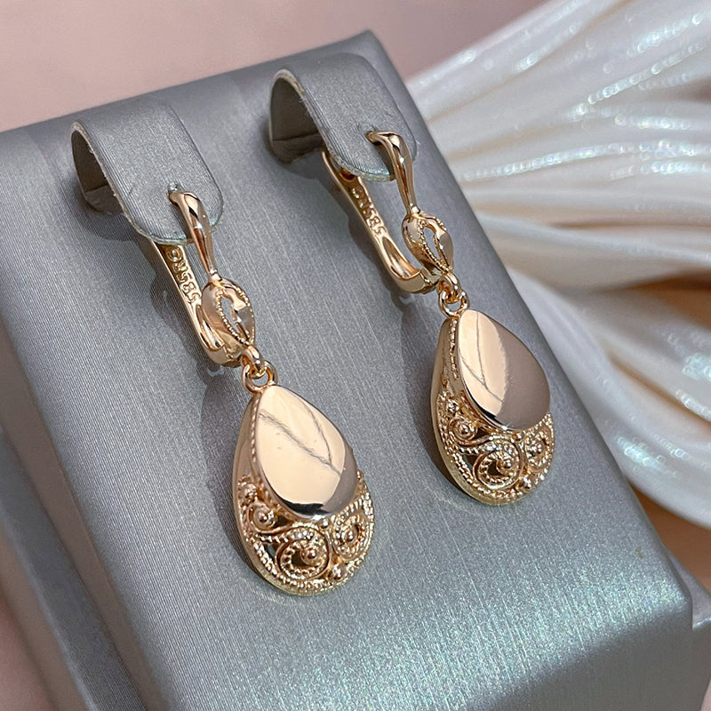 Elegant pink earrings with teardrop-shaped filigree detailing
