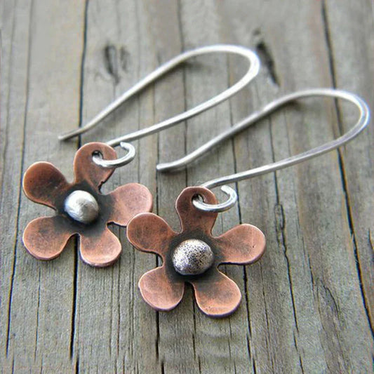 Handmade copper flower earrings with a domed metallic accent