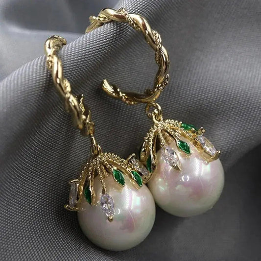Elegant freshwater pearl stud earrings with cubic zirconia leaves and a sophisticated design