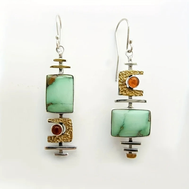 Handmade earrings featuring mottled gemstones and textured metal details
