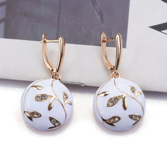 Elegant white enamel earrings featuring a rhinestone leaf design