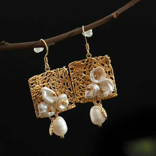 Earrings featuring baroque pearl flowers in a woven square design