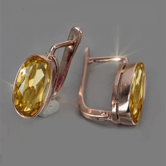 Vintage-style oval yellow glass earrings with a rose-coloured finish