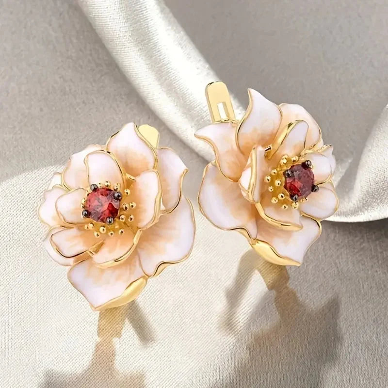 White enamel flower earrings with ruby-red cubic zirconia details