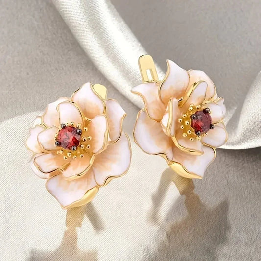 White enamel flower earrings with ruby-red cubic zirconia details