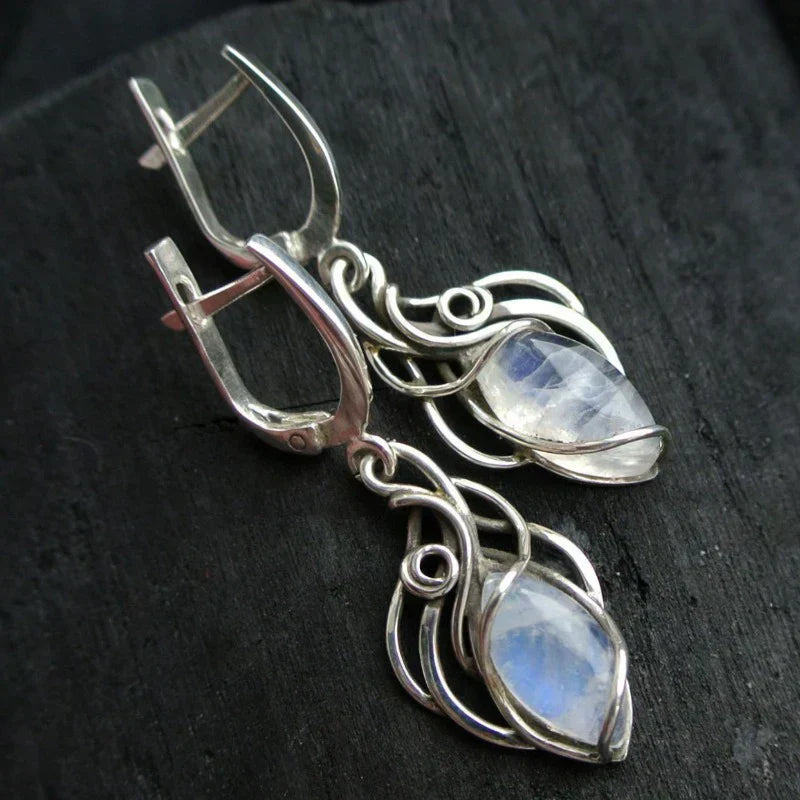 Elegant earrings featuring iridescent moonstone and artistic wire mesh