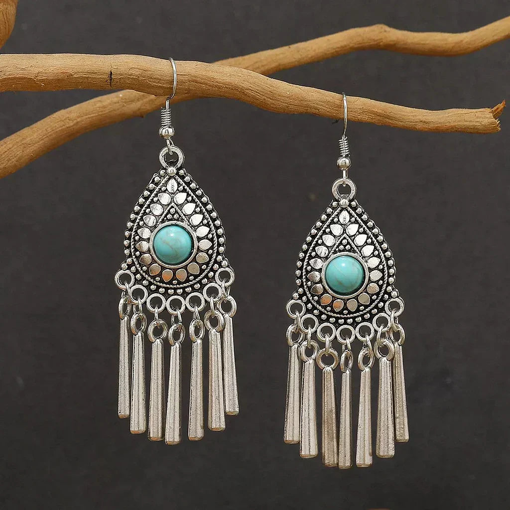 Vintage earrings featuring a teardrop and turquoise tassel design