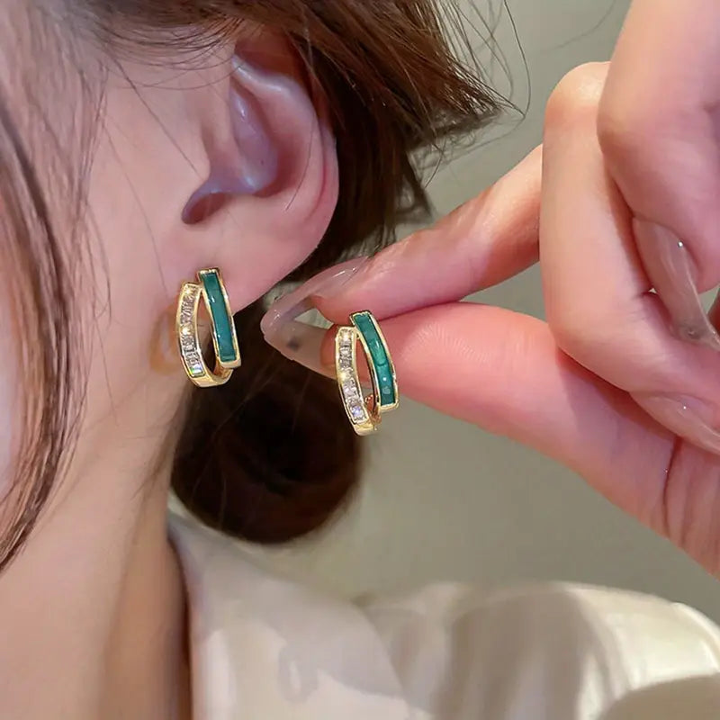 Elegant hoop earrings with bright green enamel and sparkling cubic zirconia stones