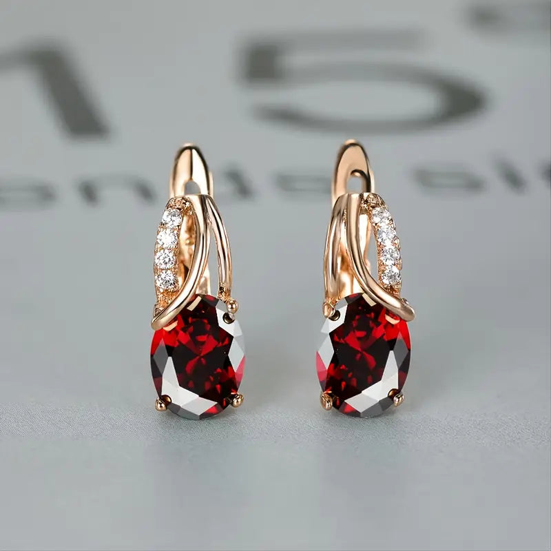 Earrings featuring sparkling ruby-red cubic zirconia stones, perfect for elegant occasions
