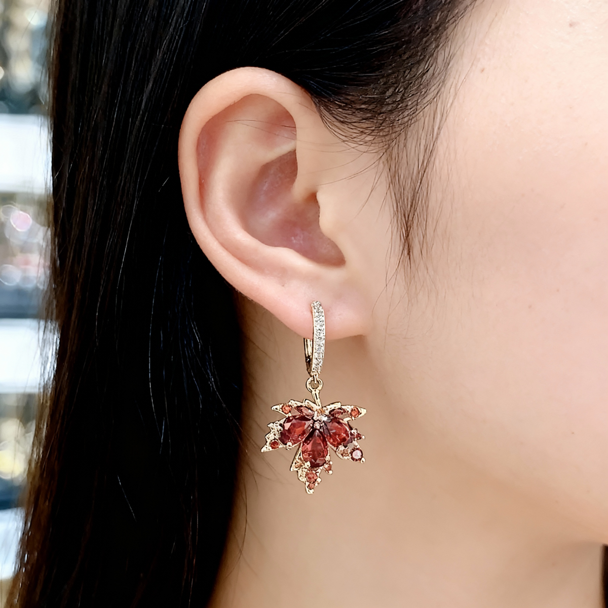 Elegant maple leaf earrings with sparkling red cubic zirconia stones
