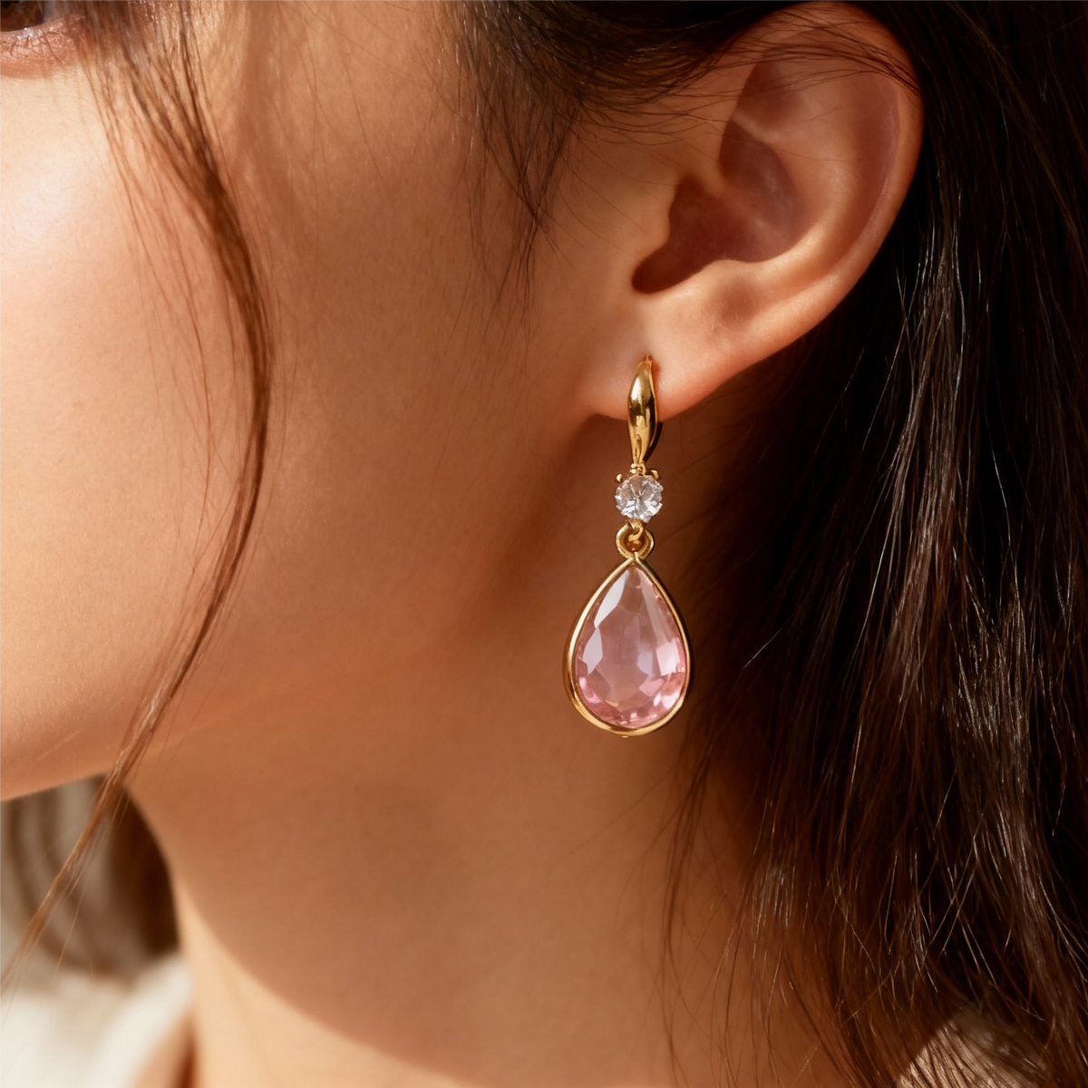 Elegant earrings featuring a pink teardrop-shaped stone and sparkling cubic zirconia