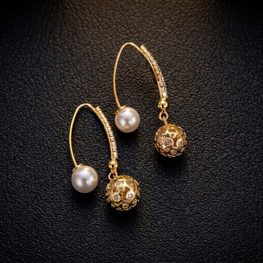 Elegant pearl earrings with artistic ball-shaped pendants and sparkling cubic zirconia stones