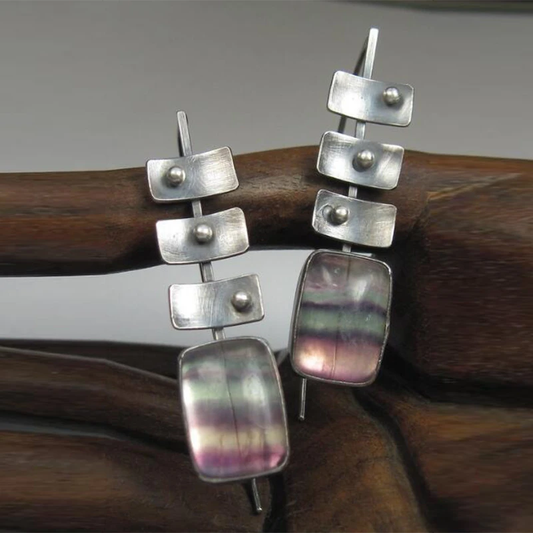 Modern earrings featuring rainbow fluorite stones and geometric elements
