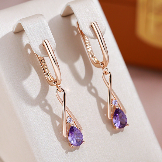 Elegant earrings featuring purple cubic zirconia drops and a rose gold finish