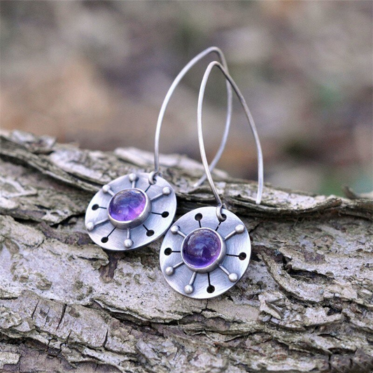 Handmade earrings featuring amethyst stones and a rustic design