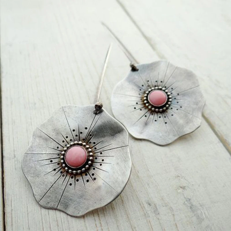 Boho-style petal earrings with a pink gemstone centrepiece