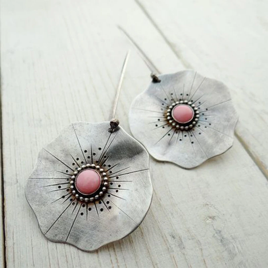 Boho-style petal earrings with a pink gemstone centrepiece