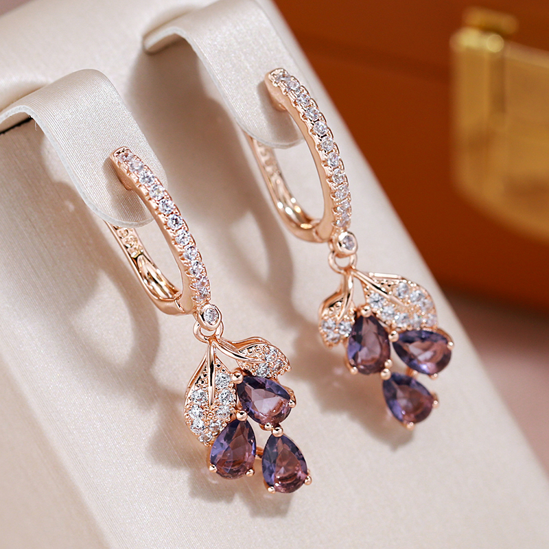 Elegant rose gold-coloured earrings with amethyst crystals and sparkling cubic zirconia stones