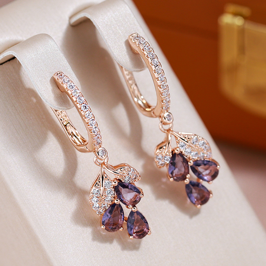 Elegant rose gold-coloured earrings with amethyst crystals and sparkling cubic zirconia stones