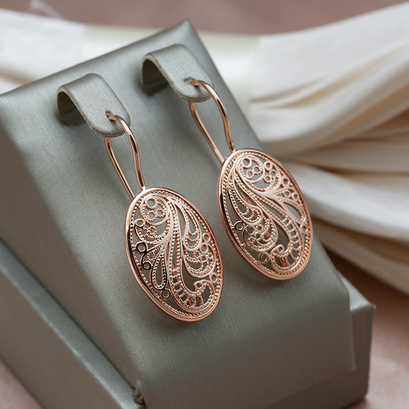 Elegant earrings with a delicate pattern in a bright shade of pink