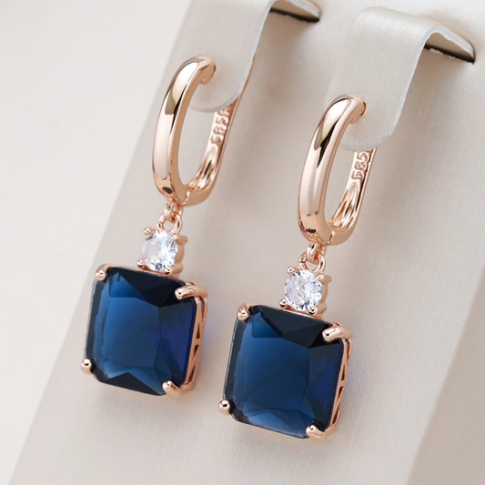 Elegant earrings with blue cubic zirconia and a pink finish