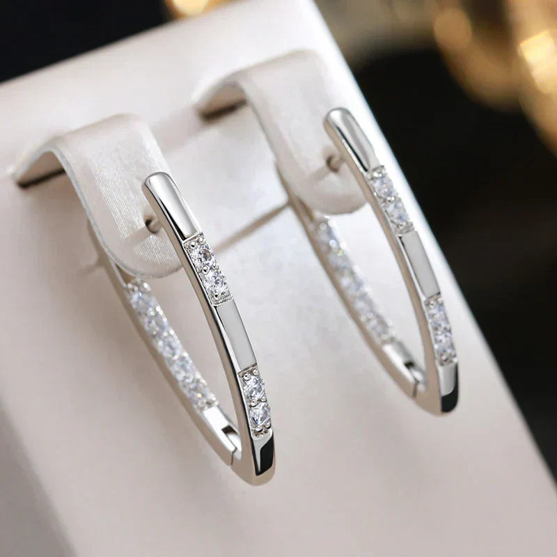Shiny oval hoop earrings with cubic zirconia and an elegant design