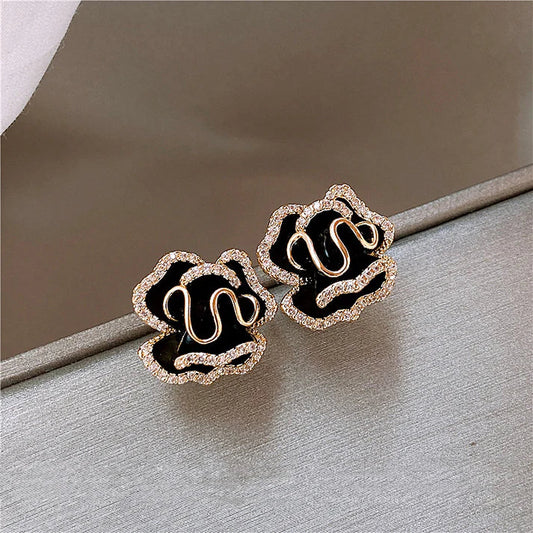 Elegant earrings featuring a black lotus flower and sparkling details