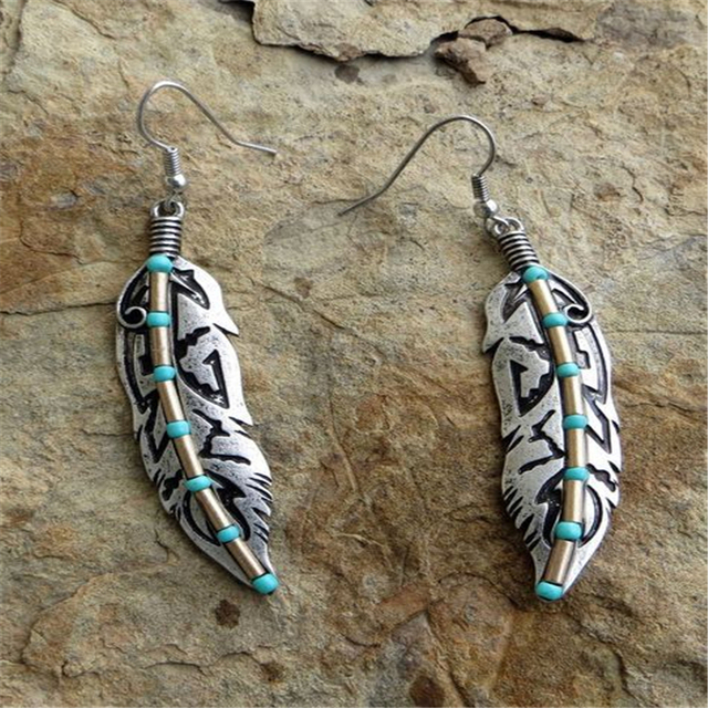 Vintage feather earrings with turquoise detailing in a bohemian style
